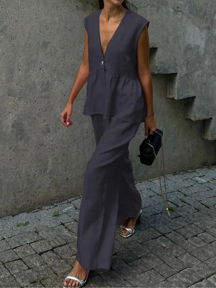 Kostym i bomull och linne, med V-ringning och volanger, bestående av två delar