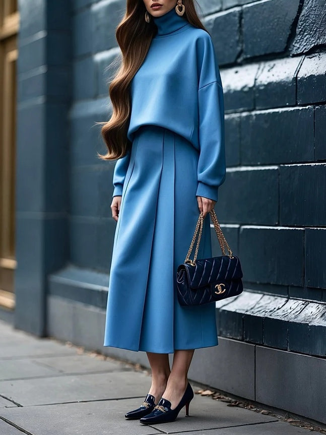 Set med två delar: Top med hög krage och midi kjol