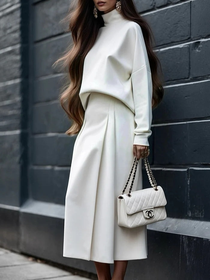 Set med två delar: Top med hög krage och midi kjol