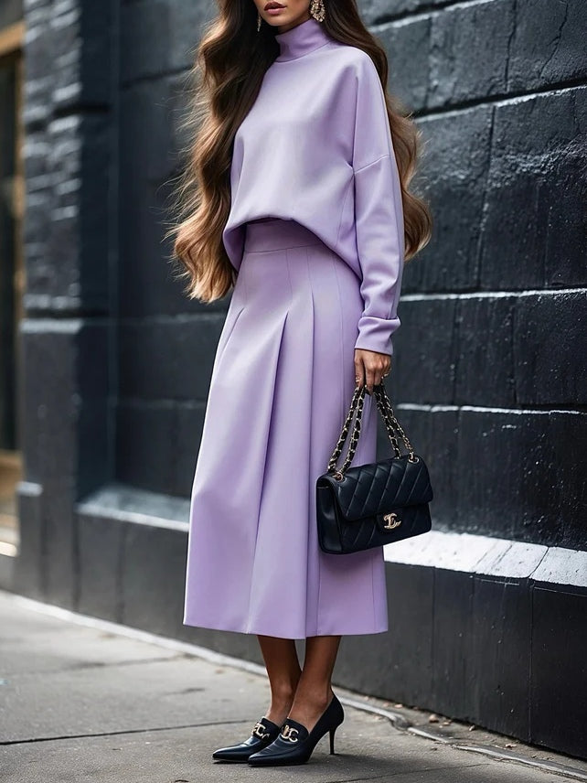 Set med två delar: Top med hög krage och midi kjol