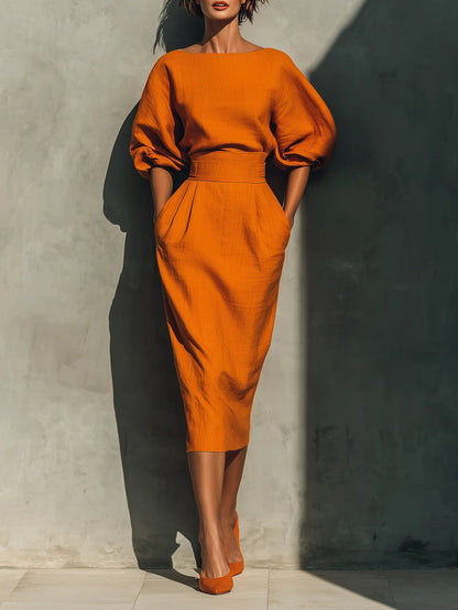 Sätt med en livfull midi kjol i bomull och lin i orange