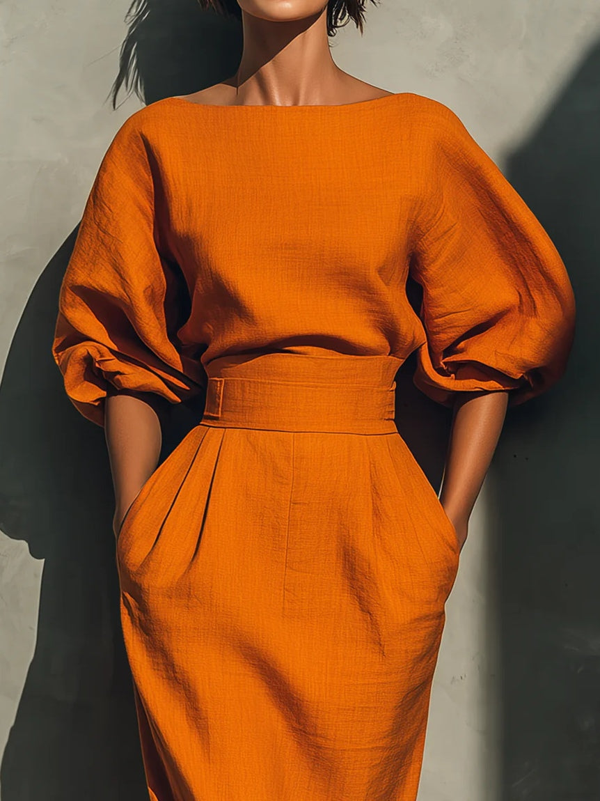 Sätt med en livfull midi kjol i bomull och lin i orange