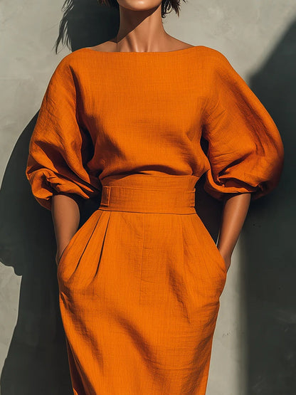 Sätt med en livfull midi kjol i bomull och lin i orange