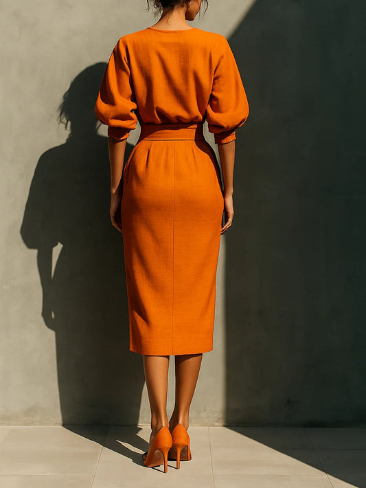 Sätt med en livfull midi kjol i bomull och lin i orange